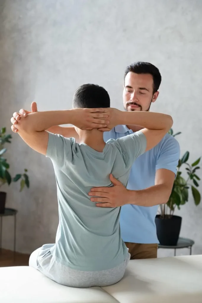 Physiotherapist conducting posture correction on a patient