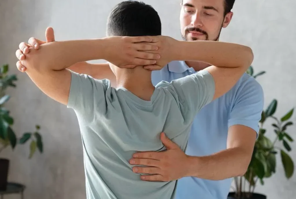 Physiotherapist conducting posture correction on a patient